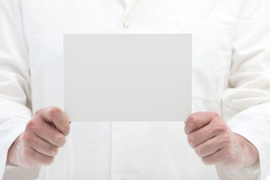 Man holding blank white card with space for your text or message in front of himself