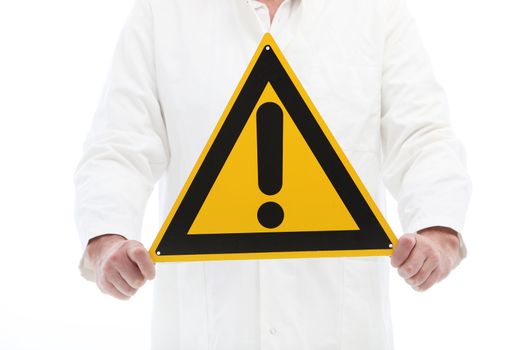 Man in a white shirt holding warning sign with exclamation point to portray a sense of urgency