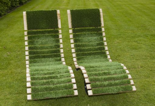 green chairs made from wood and grass