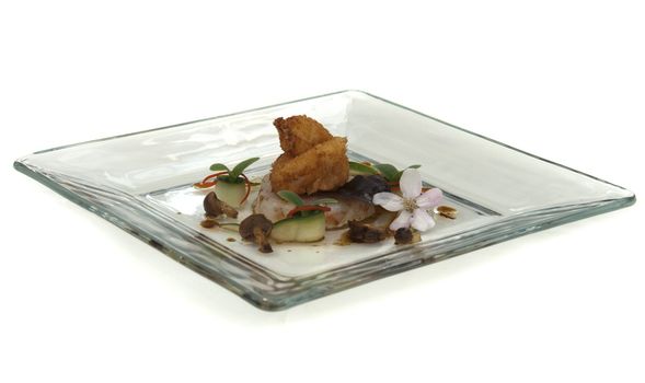 plate with fish cuisine isolated on white