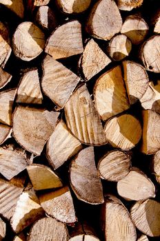Fragment of choppen firewood. Wooden texture background .