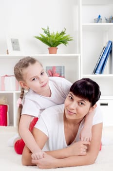 Portrait of happy family lying together, hugging and happy