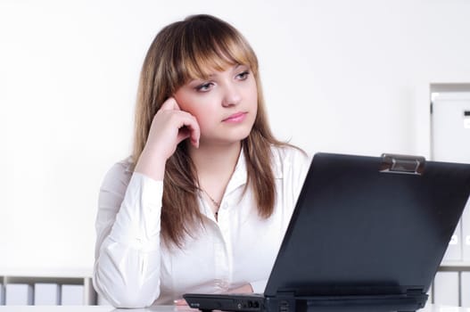 Young busines woman with notebook, in office