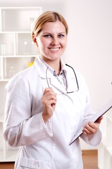 portrait of doctor, holds a tablet in the office