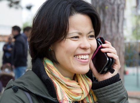 woman happy and dynamic calling with his mobile phone