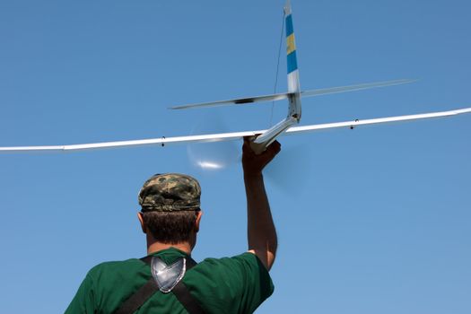 Man launches into the sky RC glider, closeup
