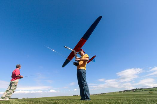 Man launches into the sky RC glider, wide-angle