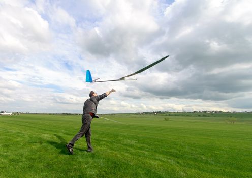 Man launches into the sky RC glider, wide-angle