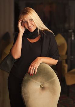 Sensual Beautiful Blonde Woman Standing Near Chair.