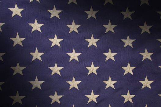 Embroidered white stars on a field of blue which represents the union on the American flag, lit diagonally