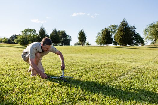 Challenging task of cutting large lawn with grass shears by hand