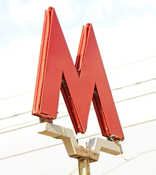 A Moscow metro sign with sky background