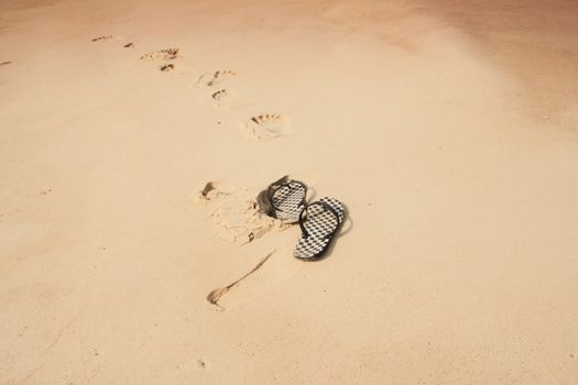 Flip-flops on the beach sand 
