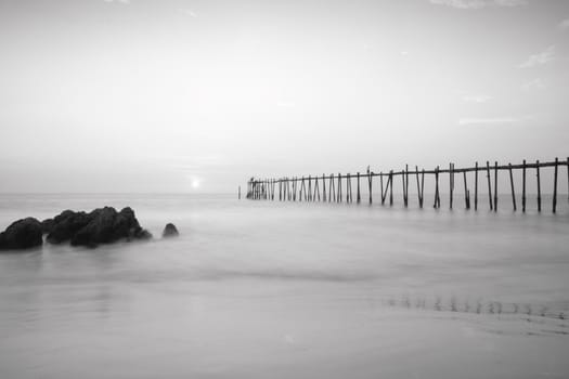 Black and white wood bridge to the sea