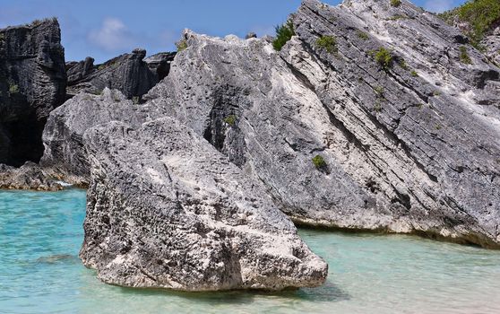 Large rocks, or boulders, in the atlantic ocean in the coastal waters of Bermuda. Photo was taken at Horseshoe Bay in Bermuda. 