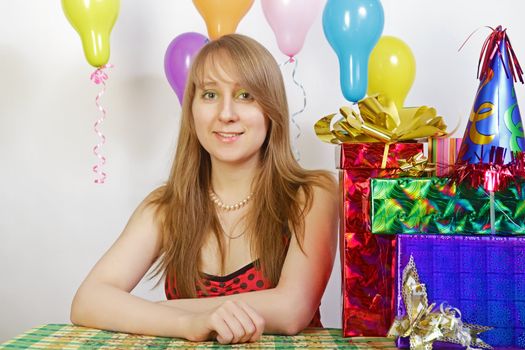 Birthday. Smiling girl with balloons and gifts