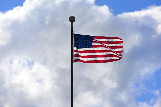 New American flag in the wind on a beautiful cloudy sunny day 