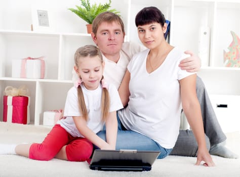 family are working together for a laptop at home