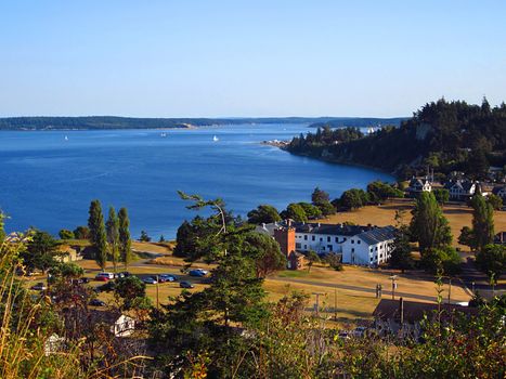 A photograph of a town located near a waterway.