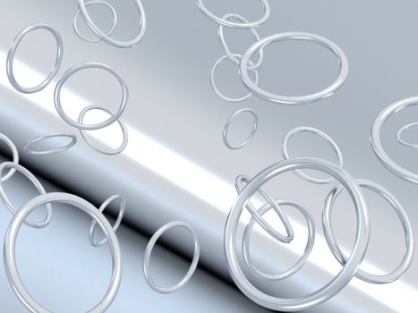 Abstract metallic rings falling on shined grey background
