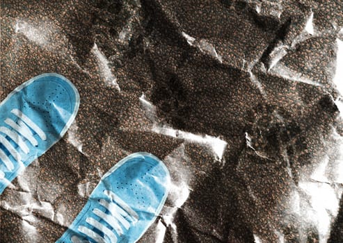 Blue sport shoe print on crumpled paper.