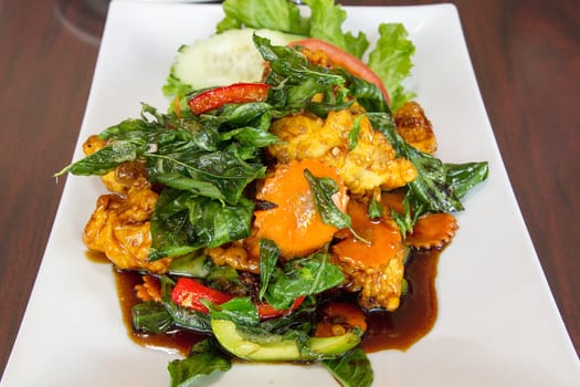 Thai Crispy Fried Chicken with Basil Leaves Bell Pepper Cucumber Tomato Dish Vertical