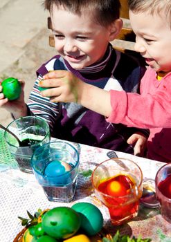 Sweet little boys fighting easter eggs