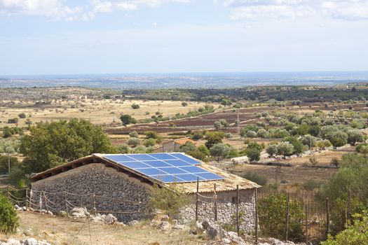 Modern technology in form of Solar electricity cells on rural house in Sicily, Italy, Europe