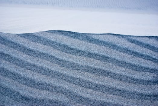 Layers of different colored sand in desert dunes