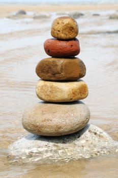 Zen pebbles stacked together on the beach.