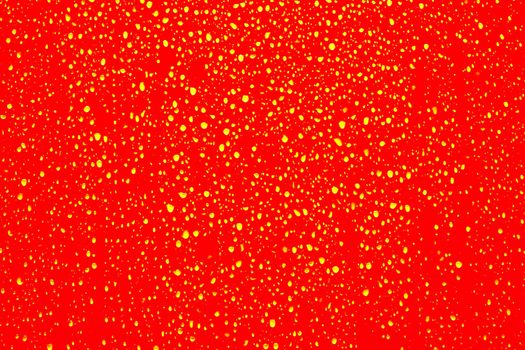 Yellow water droplets on a red surface