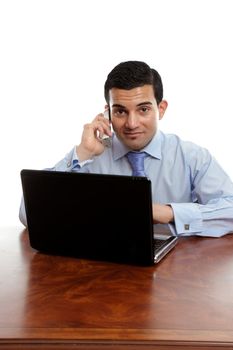 A sincere businessman taking a phone call while at work