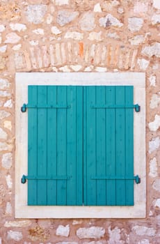 Closed green wooden window shutters, security element