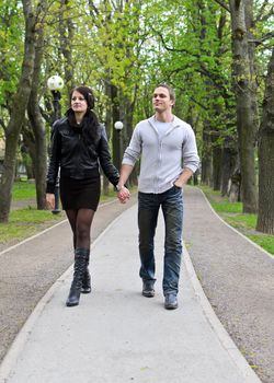 Couple walking down the road in the park.