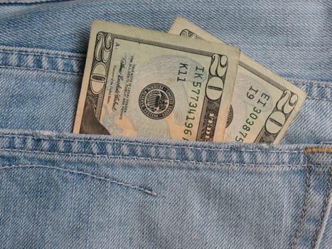 American blue jeans pocket filled with USD banknotes money 