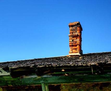 orange old chimney at an abandoned house