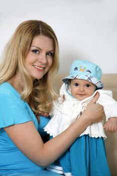 Portrait of beautiful happy smiling mather with baby intdoor