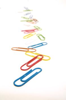 colorful paperclips on white