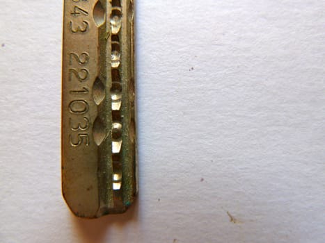 brass secure key on white as a background