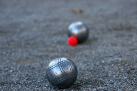 silver boccia ball on the ground