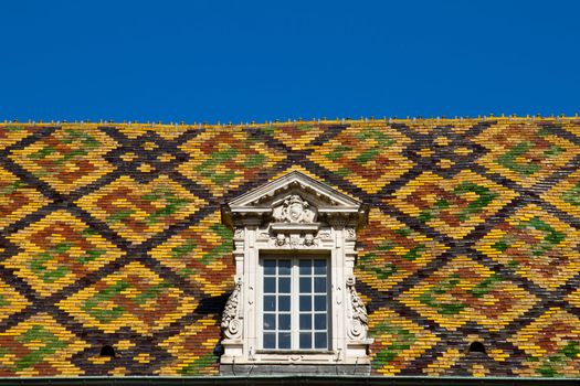 A Colored roof tile against blue sky