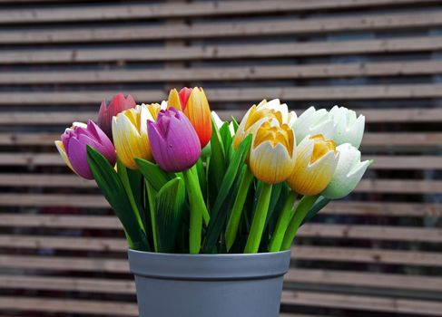 wooden tulips as decoration in yellow red pink and white