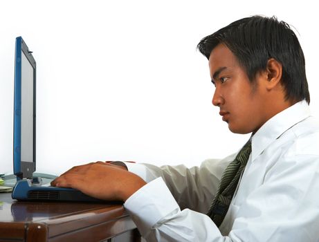 Man At His Desk In His Office Working On His Notebook Computer