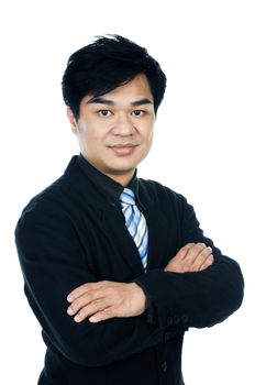 Portrait of a handsome Asian businessman with arms crossed against white background.