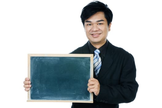 Portrait of a handsome young Asian businessman holding a blackboard over white background.