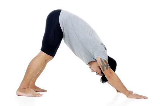 Portrait of a young Asian man doing yoga exercise on white background