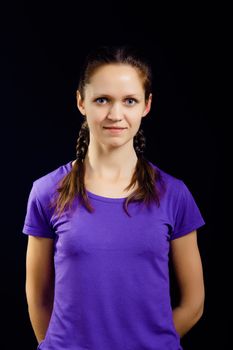 girl with pigtails in a T-shirt on a black background