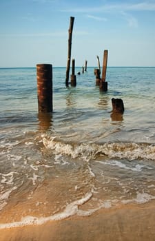 pillars from an old jetty stand in the sea