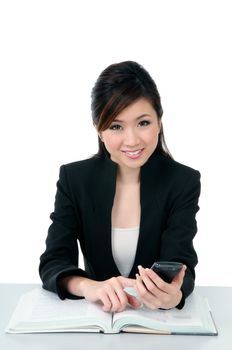 Portrait of an attractive young businesswoman holding cellphone over white background.