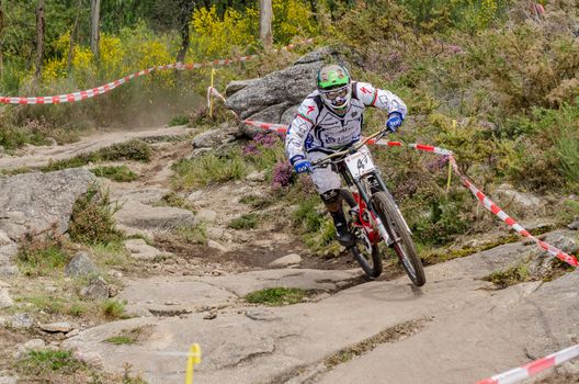 VIANA DO CASTELO, PORTUGAL - MAY 13: Daniel Pombo on a rocky terrain on the 4th Stage of the Taca de Portugal Downhill Vodafone on may 13, 2012 in Viana do Castelo, Portugal.